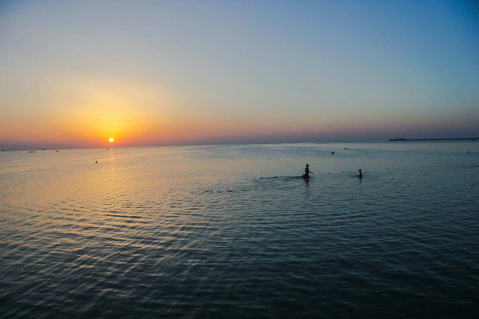 people on sea during sunset